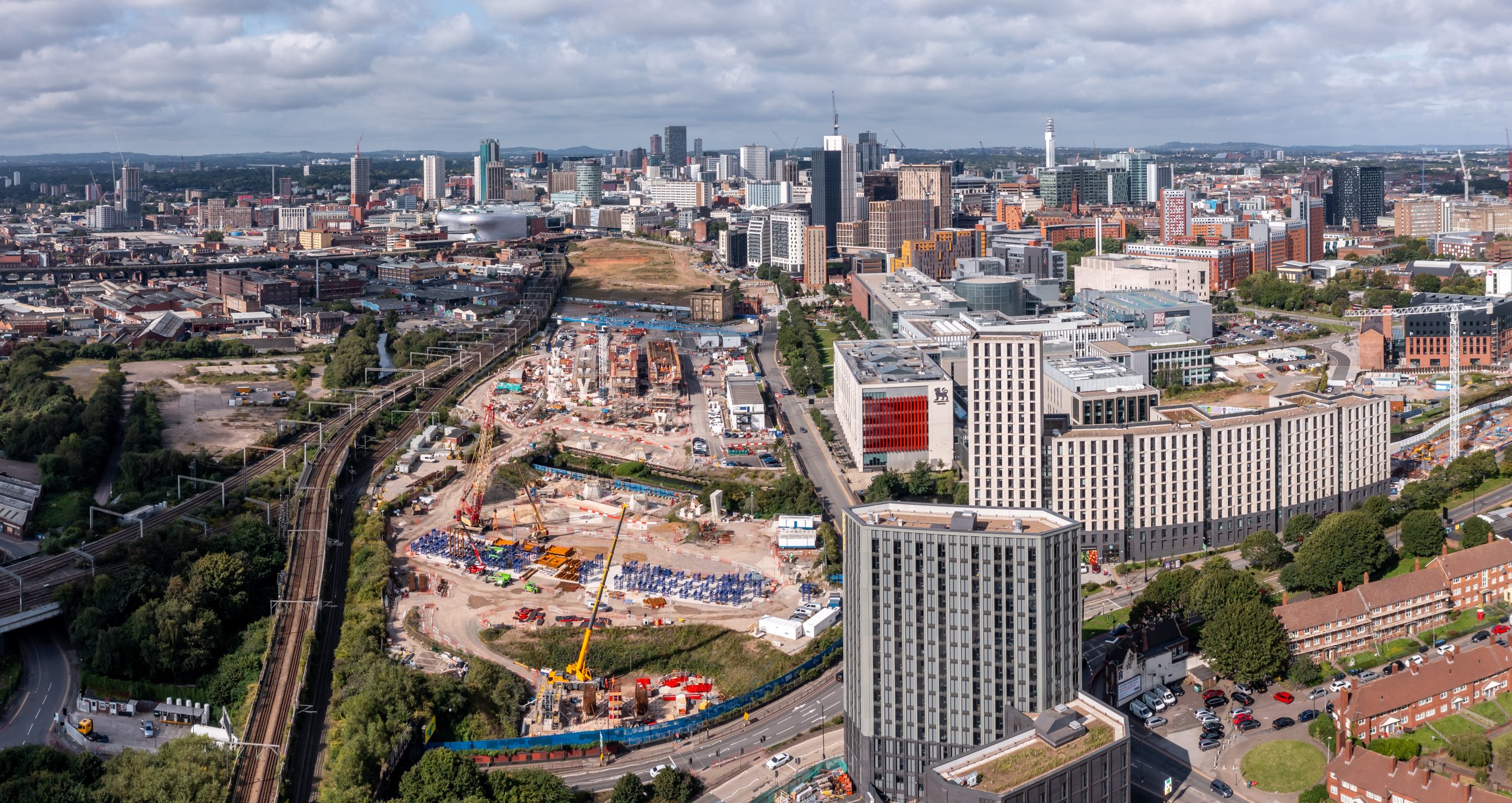 BIRMINGHAM, UK - AUGUST 21, 2023.  An aerial panoramic view of a Birmingham cityscape skyline with the new HS2 route and construction site running past Birmingham University campus