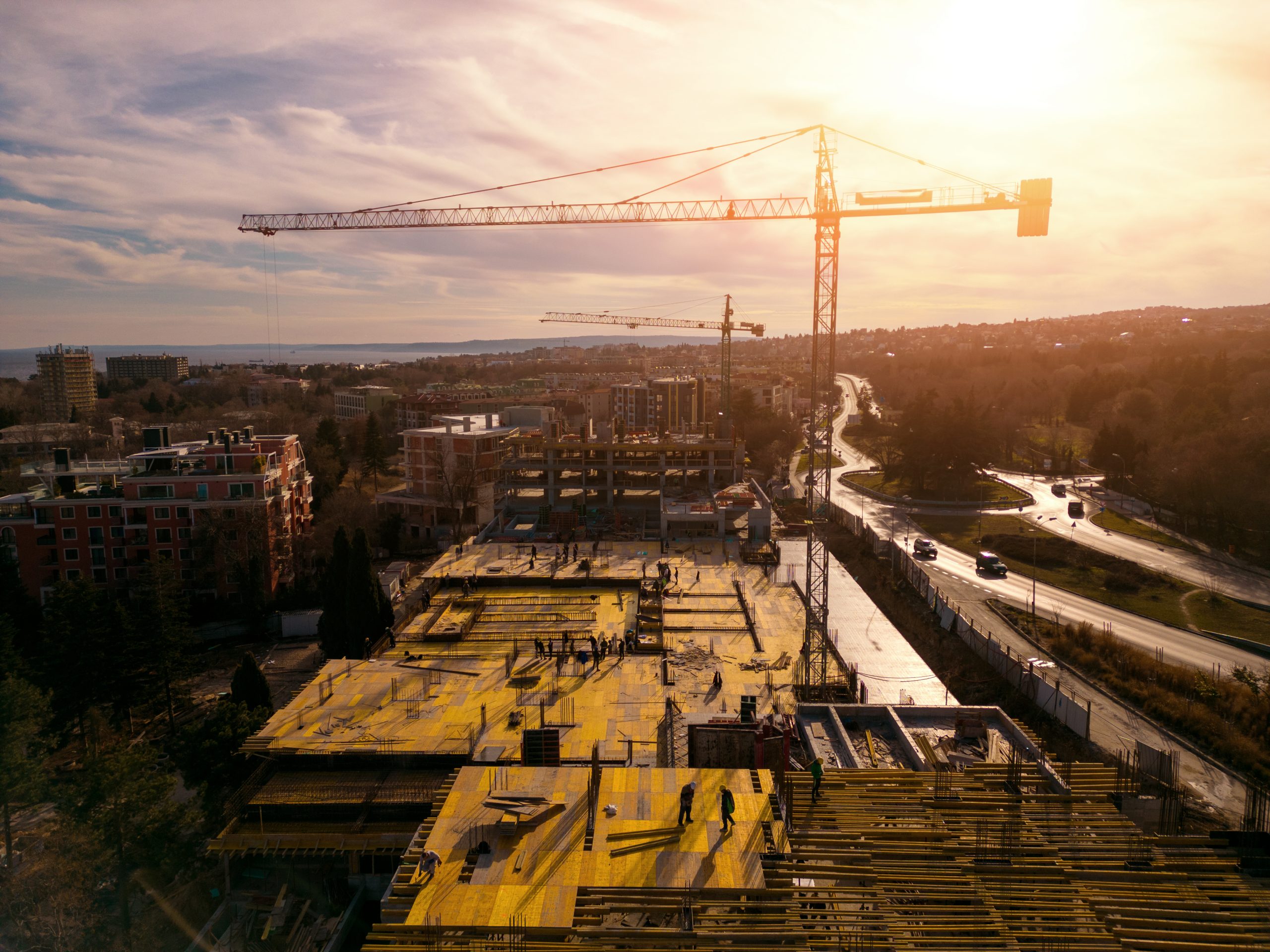 Busy Construction Site and Construction Equipment on the sea coast Aerial top view